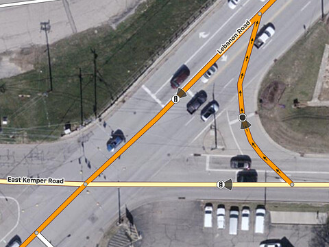 A traffic signals node is located at the midpoint between the left turn and through lanes’ respective stop lines approaching the intersection between East Kemper Road and Lebanon Road from the east