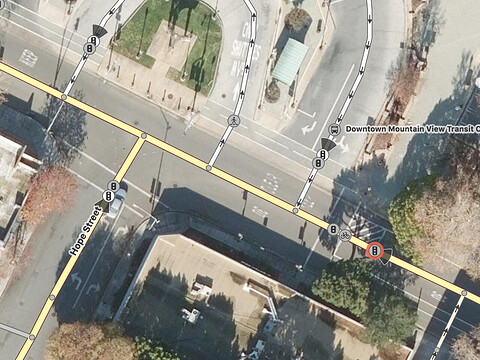 A stop line sits behind an advanced stop line for cyclists and two different service roads for buses before meeting Hope Street, which is also signalized
