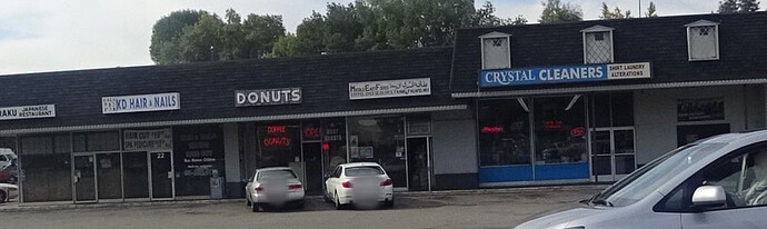 Middle East Foods sandwiched between Donuts and Crystal Cleaners in a strip mall