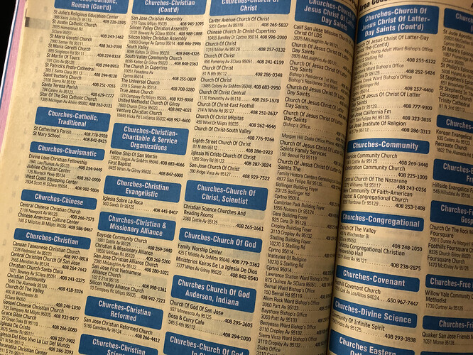 The Valley Yellow Pages for area codes 408 and 669, 2015–2016 issue, pages 100 and 101, section Churches. The section is broken down into subheadings by denomination: Catholic, Roman; Catholic, Traditional; Charismatic; Chinese; Christian; Christian-Charitable & Service Organizations; Christian Evangelistic; Christian & Missionary Alliance; Christian Reformed; Christian Science; Church Of Christ; Church Of Christ, Scientist; Church Of God; Church Of God, Anderson, Indiana; Church Of God In Christ; Church Of God Of Prophecy; Church Of Jesus Christ Of Latter-Day Saints; Community; Congregational; Covenant; Divine Science; Eastern Orthodox; Episcopal; Evangelical; Evangelical Free; Foursquare Gospel; Free Methodist; Friends; Full Gospel; Hindu; Independent Bible; etc. Under the heading “Church Of God, Anderson, Indiana”, the second of two entries is for Dosa & Curry Cafe. (Data in the public domain under federal law. Layout and presentation © 2015 AGI Publishing, Inc.; fair use for noncommercial commentary on the layout.)