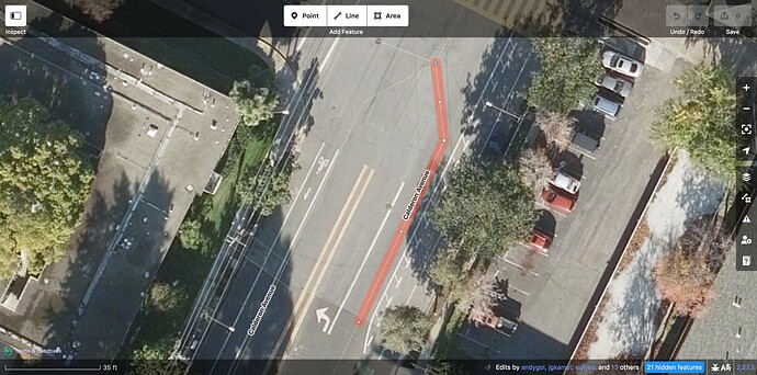 Along the highlighted way, there is a left turn lane, an unmarked through lane, some buffer, and a bike lane.