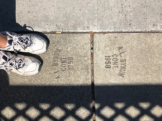 On a stroll around the neighborhood, I came upon two sidewalk tiles stamped with a construction date of 1958, allowing me to put an upper bound on the start date of both the sidewalk and the street. This can be the start date of the sidewalk in OSM, but tagging the street with this inference would have been quite a stretch for OSM, because it’s too tangential to most use cases for roads in OSM.