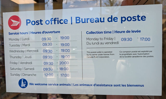 A photo of a placard with Canada Post branding that says "Post Office", lists its opening hours and collection times, and includes a small note that the postal outlet is operated by its owner under license from Canada Post