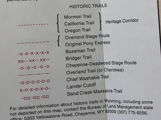 A legend of historic trails such as the Mormon Trail, Bozeman Trail, and Bridger Trail, marked by a variety of line types, such as dashes, dashes and exes, and dashes and circles. (© 2010 Wyoming Department of Transportation)