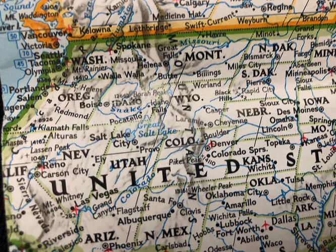 A wall map of the United States labels the Nevada cities of Reno, Carson City, Ely, and Las Vegas.