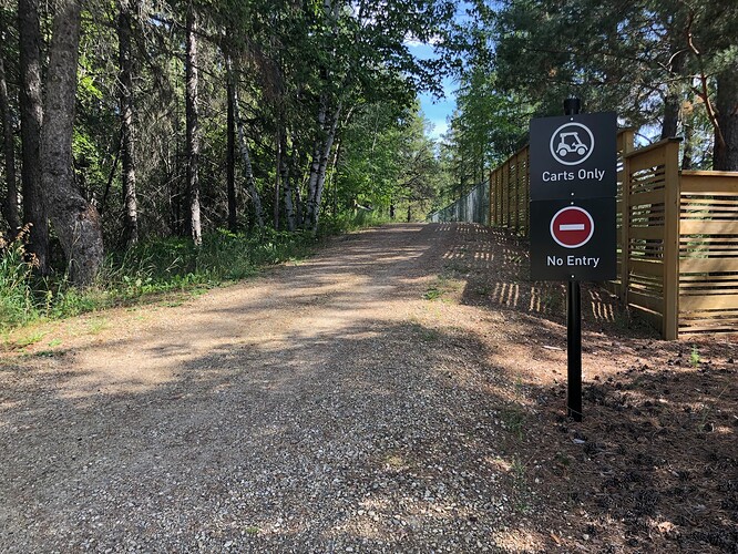 A mulched path with a signpost stating Carts Only and No Entry.