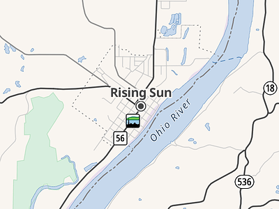 Route 56 is concurrent with the Ohio River Scenic Byway through the town of Rising Sun. The ORSB shield is represented by a rectangle with a black silhouette of a skyline, blue river, green hills, and white sky.